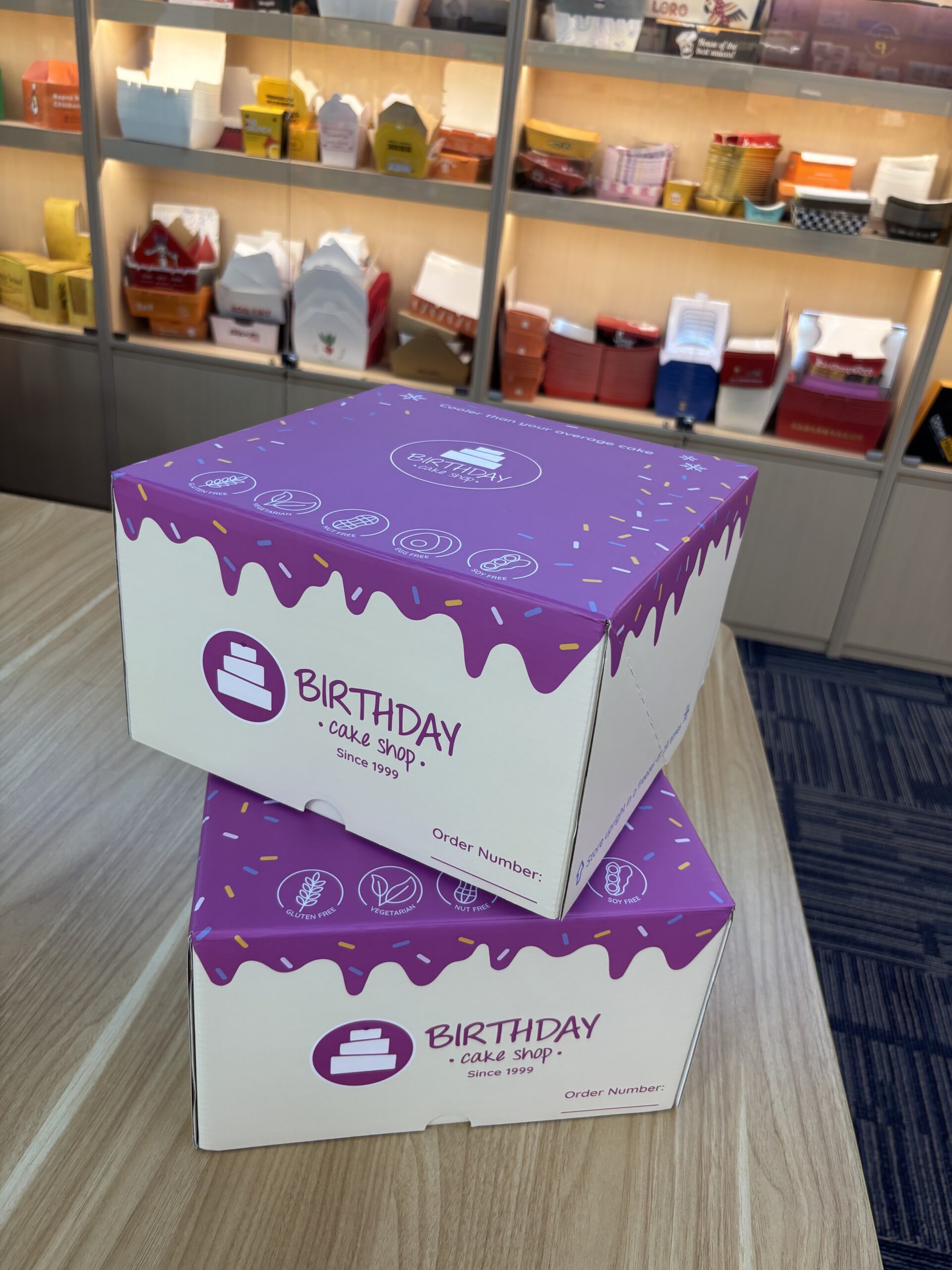 custom cake boxes white corrugated with purple drip design stacked